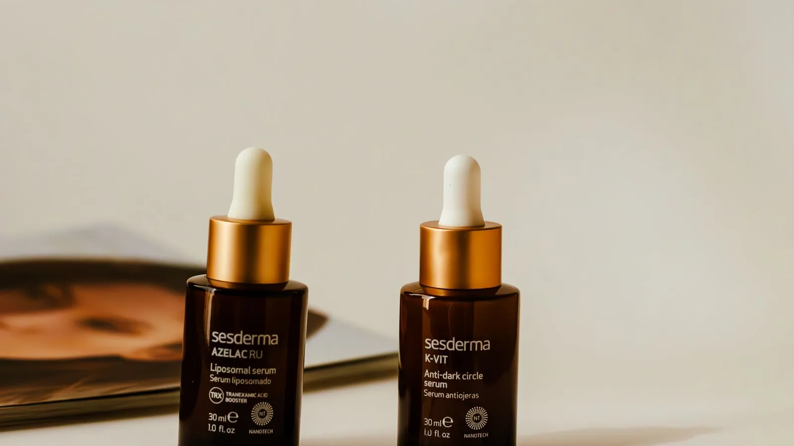 Liposomal and anti-dark circle serums showcased in stylish amber bottles with droppers.