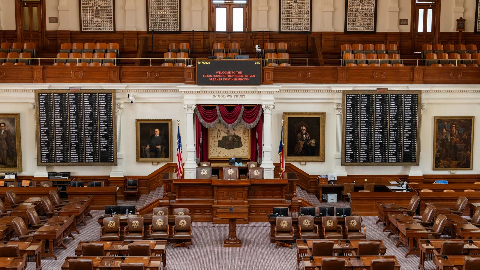 The Texas House of Representatives chamber, featuring legislative seats and historical portraits.