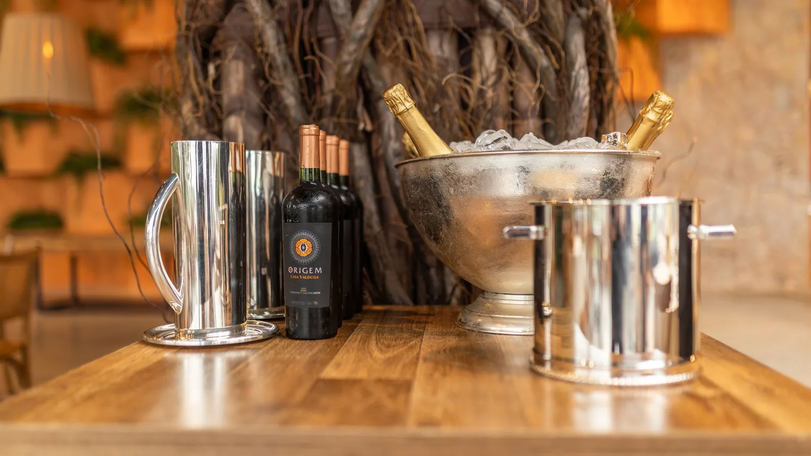 Close-up of champagne and wine bottles on a wooden table, perfect for celebrations.