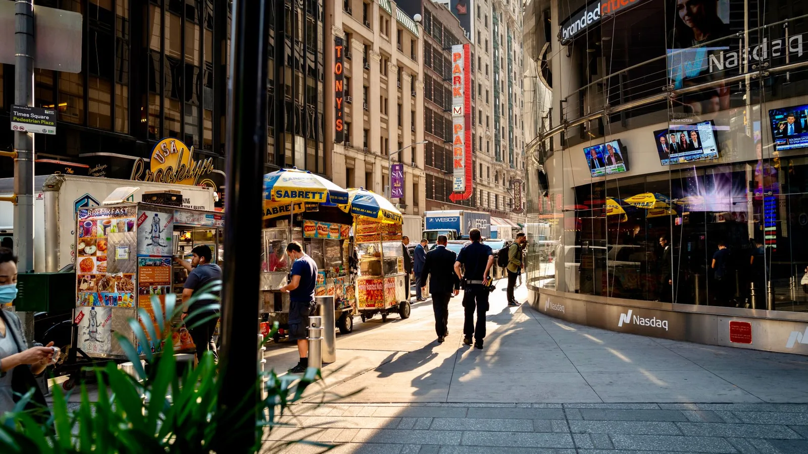 Bustling street vendors and pedestrians in iconic Times Square, New York City.
