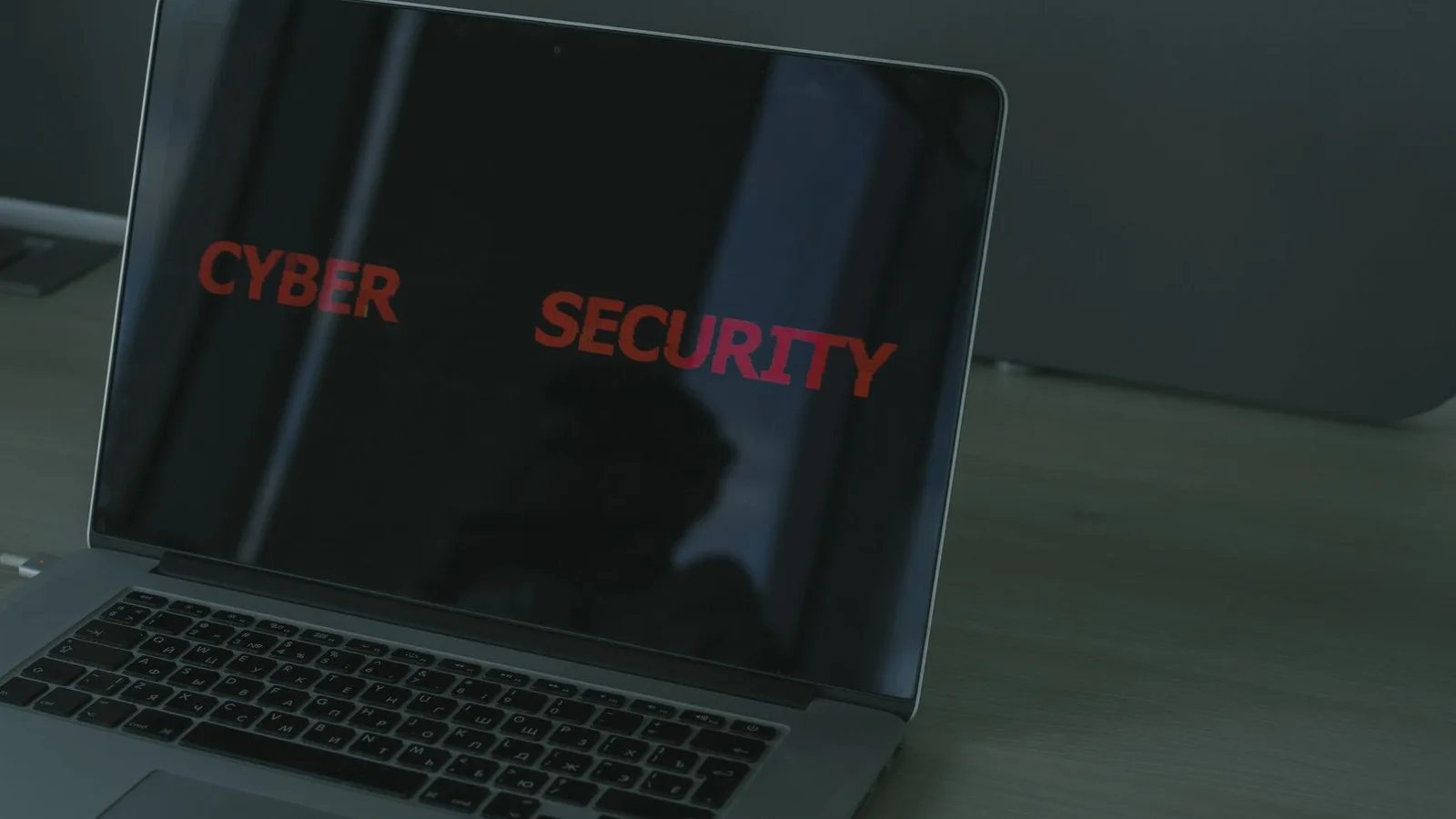 Close-up of a laptop displaying cybersecurity text, emphasizing digital security themes.