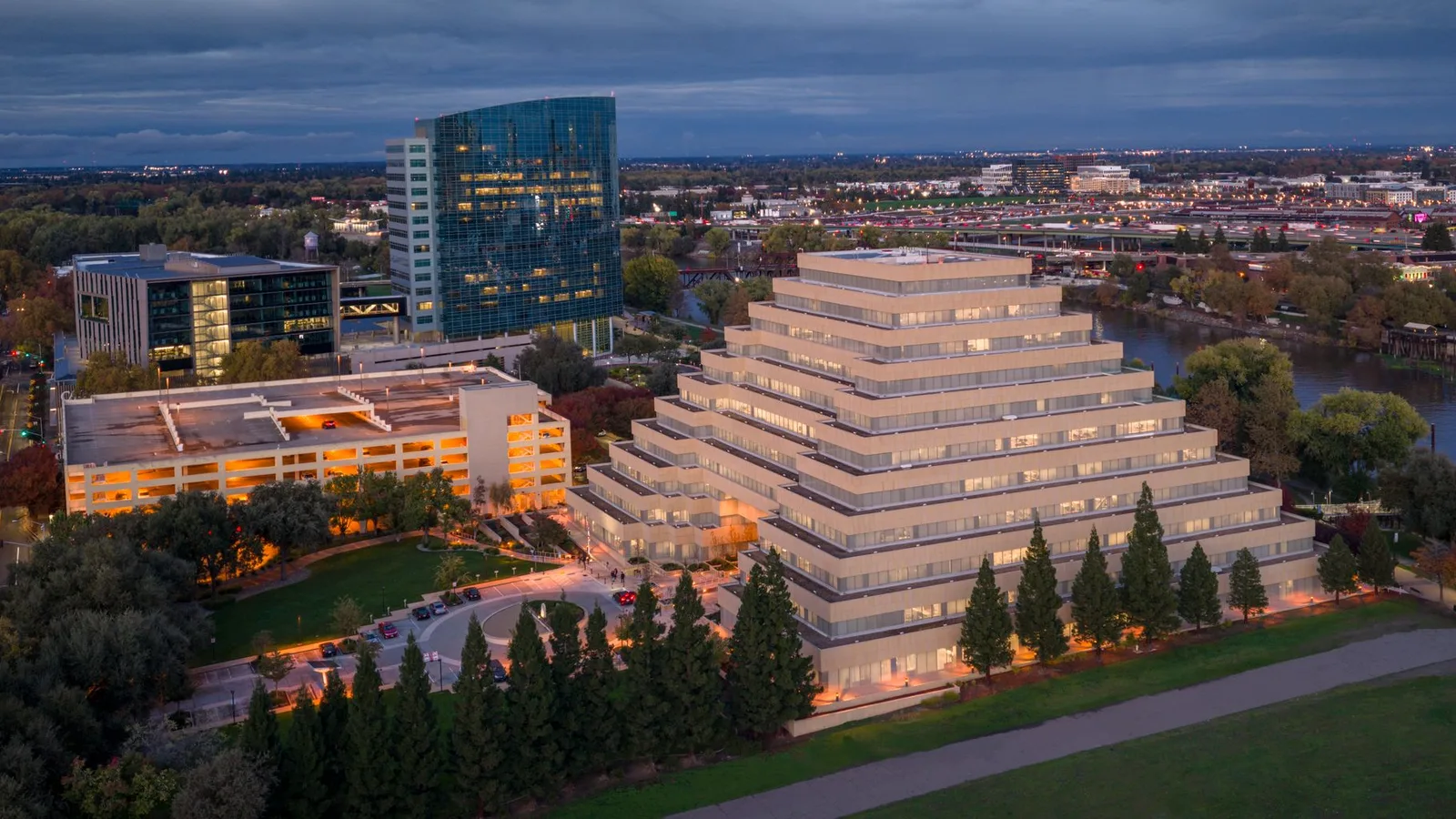Aerial view of Sacramento's iconic Pyramid Building beautifully illuminated during twilight.